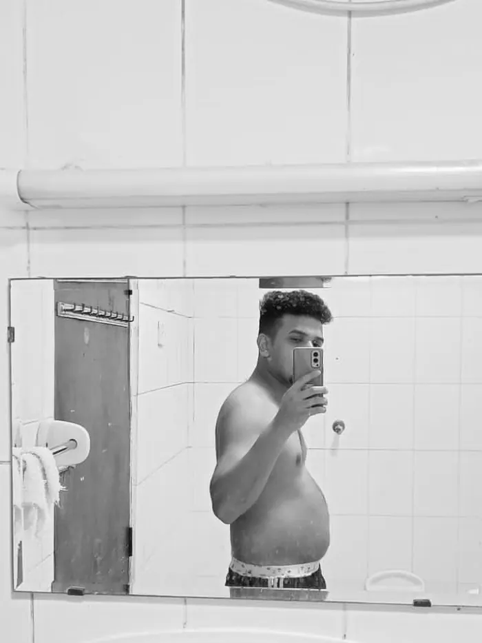 Client two before the program — higher body fat, mirror selfie
